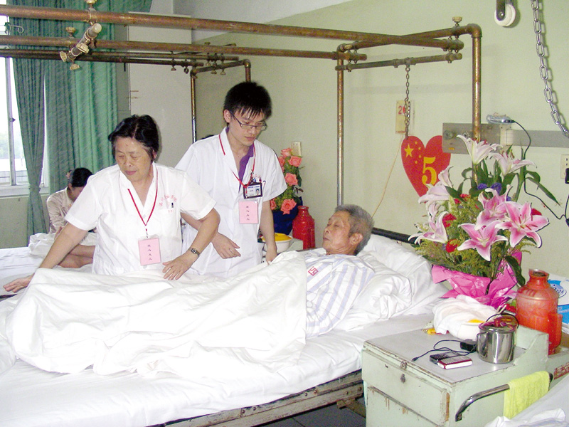 2008年5月29日，我院志愿者69岁的退休老护士长吴翠松（左）在亲切地和伤员交谈，抚慰伤员心灵上的伤痛。.jpg